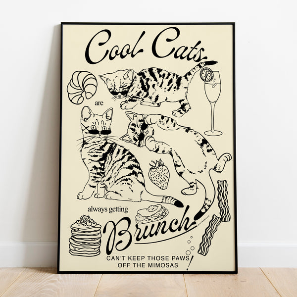 a poster leaning against a wall featuring three kittens alongside breakfast and brunch foods with the phrase cool cats are always getting brunch and the phrase can't keep those paws off the mimosas below