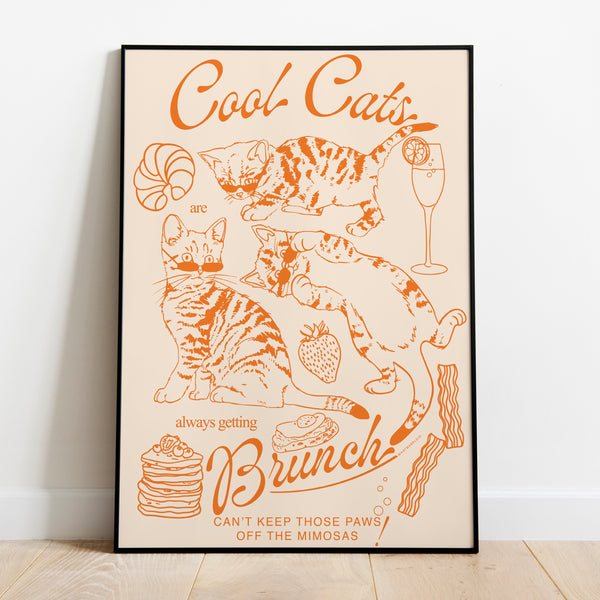 a poster leaning against a wall featuring three kittens alongside breakfast and brunch foods with the phrase cool cats are always getting brunch and the phrase can't keep those paws off the mimosas below