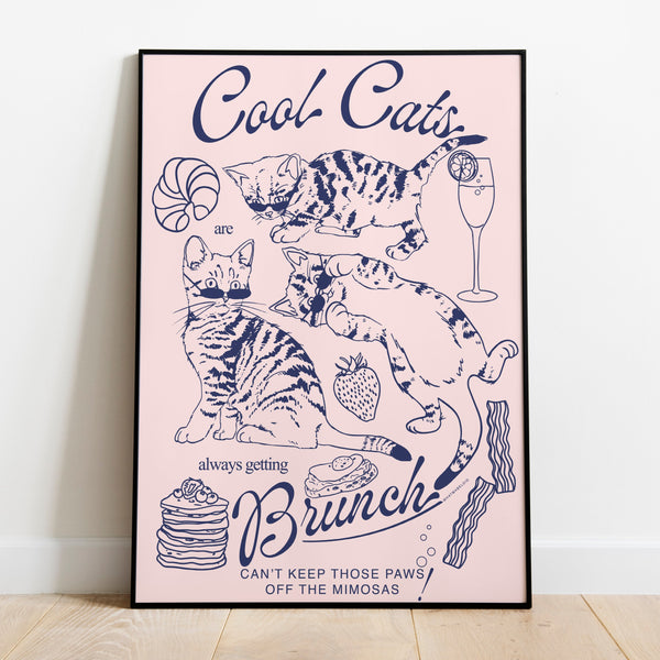 a poster leaning against a wall featuring three kittens alongside breakfast and brunch foods with the phrase cool cats are always getting brunch and the phrase can't keep those paws off the mimosas below
