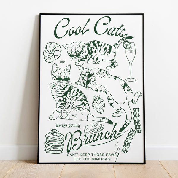 a poster leaning against a wall featuring three kittens alongside breakfast and brunch foods with the phrase cool cats are always getting brunch and the phrase can't keep those paws off the mimosas below