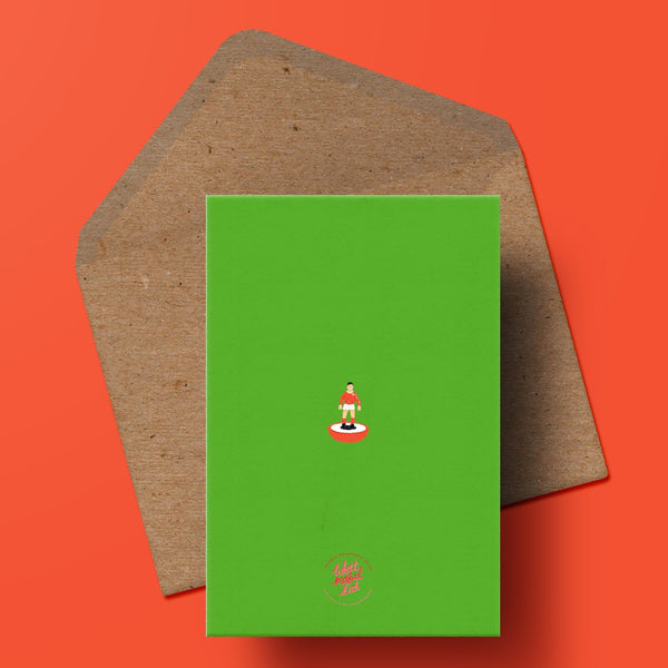 Image of the back of a father's day card in green with a small subbuteo man and the whatmabeldid logo, the card sits on top of a recycled kraft envelope