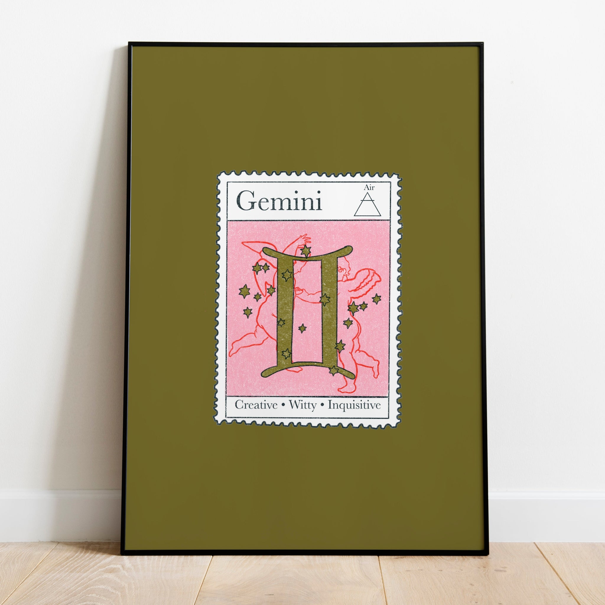 mage of a framed art print leaning against the wall. The art print itself is a postage stamp representing the star sign of gemini. The print is bright and colourful in shades of green, pink and red.