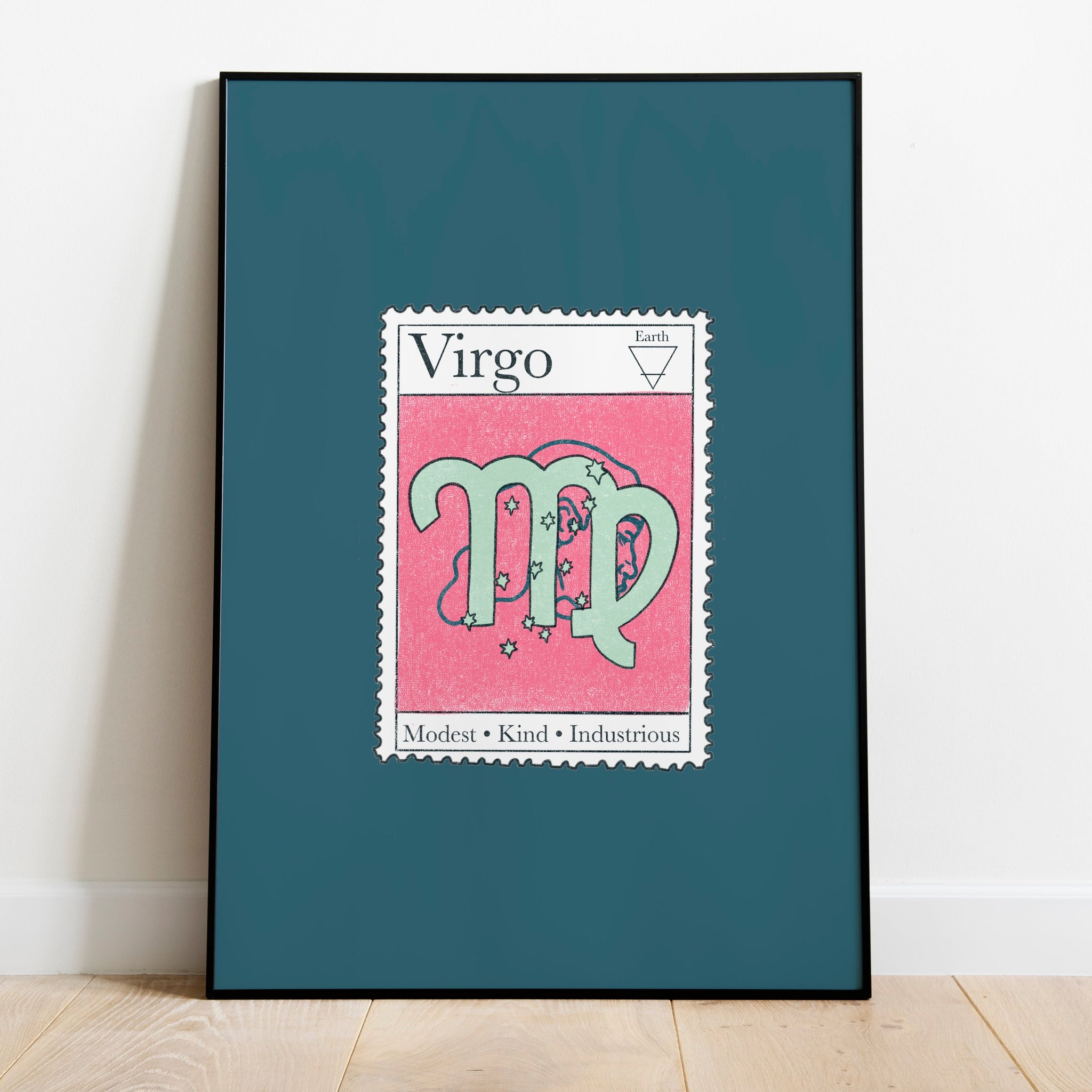 Image of a framed art print leaning against the wall. The art print itself is a postage stamp representing the star sign of virgo. The print is bright and colourful in shades of teal, blue and pink.