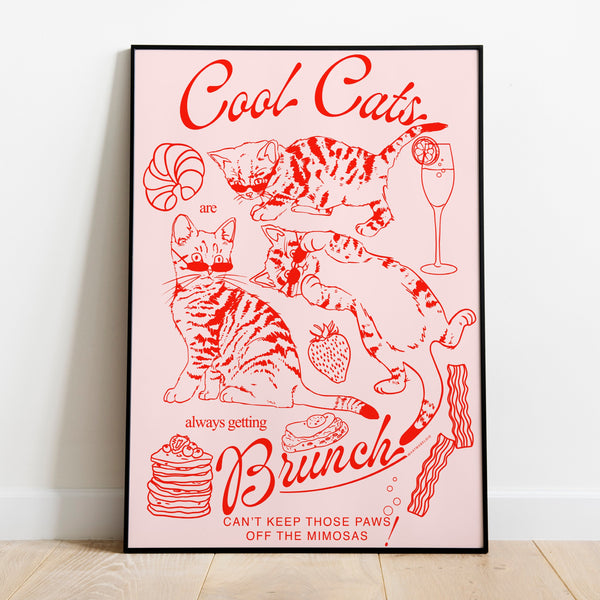 a poster leaning against a wall featuring three kittens alongside breakfast and brunch foods with the phrase cool cats are always getting brunch and the phrase can't keep those paws off the mimosas below