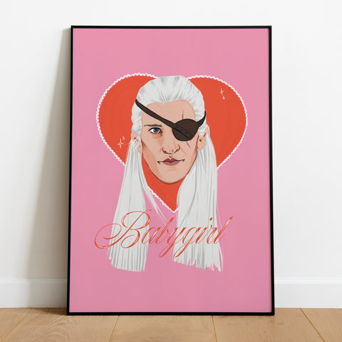 image of a framed print featuring a portrait of Aemond Targaryen from House of the dragon on a bright pink background with a red love heart behind him. The word babygirl is written beneath him in cursive.
