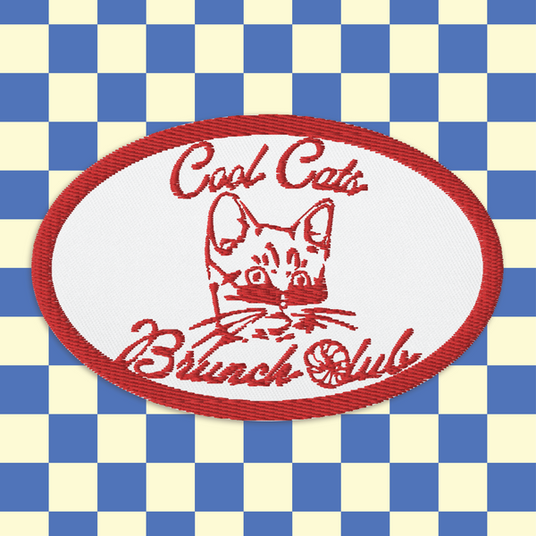 image of  an embroidered patch with the words cool cats brunch club on it in bright red. In the middle of the patch is the head of a kitten wearing sunglasses. the C of the 'club' is made out of a croissant