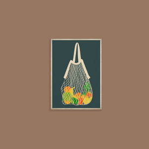 image of a framed art print featuring fruits and vegetables in a string bag on a dark background