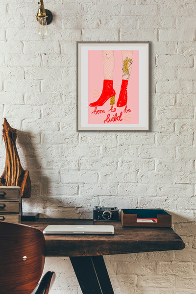 illustration print of a drawing of a woman in red patent boots with a leopard print heel and a tiger tattoo on her leg. the print is framed and situated in a minimal loft apartment type space.