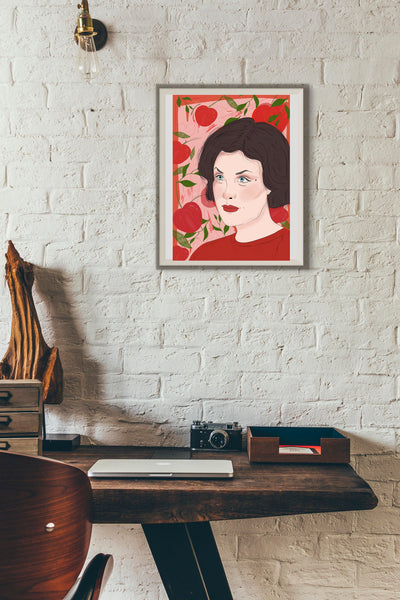 An illustration print of Sherilyn Fenn as Audrey Horne from Twin peaks with a background of cherries. the print is framed within a modern loft type space.
