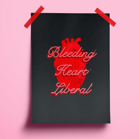 an image of a typography print featuring the words 'bleeding heart liberal' in cursive atop an anatomical heart. the background of the print is a deep dusky navy.