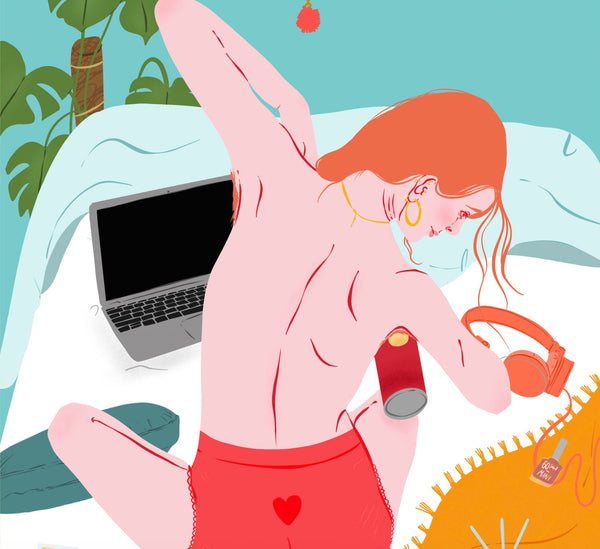 a zoomed in look at an illustration print of a young woman sat on a bed eating crisps out of a tube. she has her back to us and all around there are different items of soft furnishings including blankets and cushions. her laptop and phone are in fron tof her along with a large print, a mirror and a montserra plant.