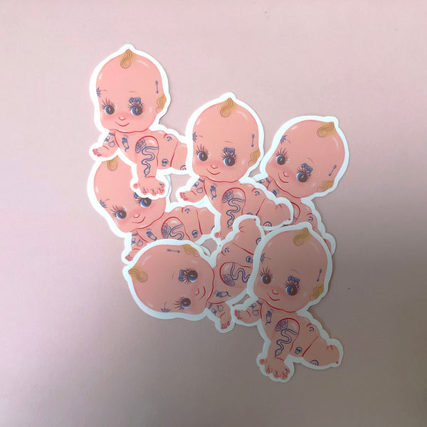 image of several stickers featuring an illustration of a kewpie doll with a collection of tattoos.