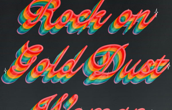 a zoomed in look at a typography print with the words rock on gold dust woman written in rainbow cursive on a deep navy background.