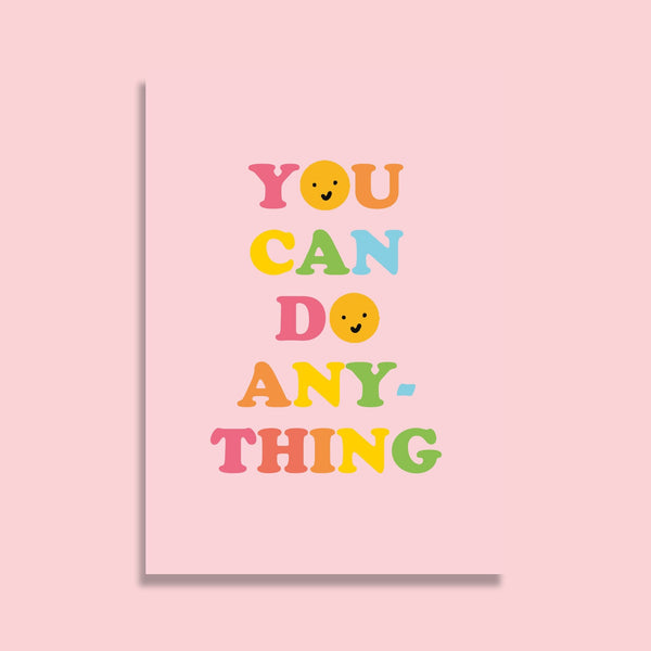 postcard featuring the words you can do anything in an alternating rainbow colour palette. the Os are replaced with smiley faces. the background is a pale pink.