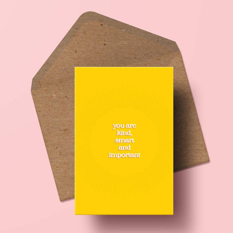 an image of a card featuring typographic print with the words 'you are kind, smart and important' overlaid onto a yellow background with subtle sunburst detailing. the card is sat on top of a kraft envelope.