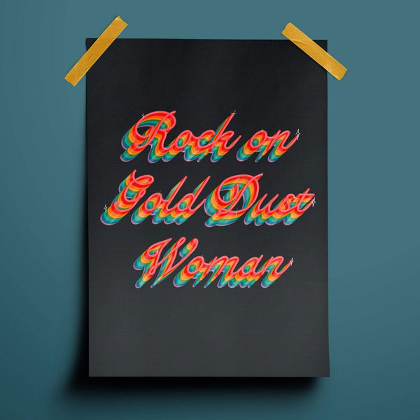 Typography print with the words rock on gold dust woman written in rainbow cursive on a deep navy background.