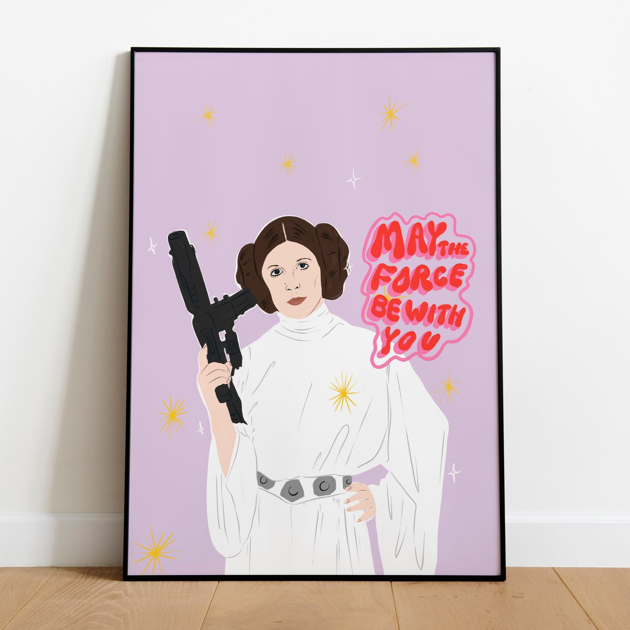 image of a framed art print featuring an illustration of Princess Leia alongside the hand lettered words 'may the force be with you'.