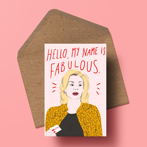 image of a greetings card featuring an illustration of samantha jones from sex and the city with handwritten type saying 'hello my name is fabulous in red text above her. behind the card is a recycled kraft envelope.